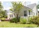 Charming backyard featuring a manicured lawn, white picket fence, and lush greenery in a residential setting at 5008 Northfield Ct, Charleston, SC 29414