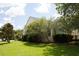 A well-maintained backyard showcasing lush green lawn and mature trees for added privacy and a serene outdoor setting at 5008 Northfield Ct, Charleston, SC 29414