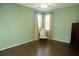 Bedroom with green walls, hardwood floors, and natural lighting at 5008 Northfield Ct, Charleston, SC 29414