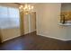 Dining area with natural light with wood floors, decorative lighting, and a pass-through to the kitchen at 5008 Northfield Ct, Charleston, SC 29414
