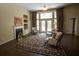 Cozy living room with fireplace, high ceilings, large windows, and elegant furnishings at 5008 Northfield Ct, Charleston, SC 29414