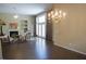 Bright living room with a fireplace, large windows, and elegant chandelier that fills the space with natural light at 5008 Northfield Ct, Charleston, SC 29414