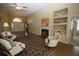 Comfortable living area with fireplace, hardwood floors, and lots of natural light through large windows at 5008 Northfield Ct, Charleston, SC 29414