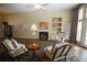 Spacious living room with neutral walls, fireplace, built-in shelving, and a large window at 5008 Northfield Ct, Charleston, SC 29414