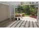 Relaxing patio with white pergola, providing shade and a peaceful spot for outdoor enjoyment and gardening at 5008 Northfield Ct, Charleston, SC 29414
