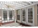 Inviting outdoor patio with white pergola, ceiling fan, and French doors leading to the interior space at 5008 Northfield Ct, Charleston, SC 29414