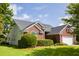 A well-maintained brick home featuring manicured landscaping and a view of the house's back side at 5008 Northfield Ct, Charleston, SC 29414