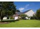 The back of a house with vinyl siding, a brick section and a big yard with some shrubbery at 5008 Northfield Ct, Charleston, SC 29414