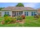 Expansive backyard showcasing a patio, screened-in porch, manicured flower beds, and a private outdoor space at 5011 W Liberty Meadows Dr, Summerville, SC 29485
