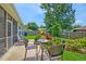 Charming backyard patio featuring an outdoor dining set and beautiful landscaping, perfect for entertaining at 5011 W Liberty Meadows Dr, Summerville, SC 29485