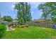 Lush backyard featuring a manicured lawn, a charming garden, and an outdoor dining area for enjoying nature's beauty at 5011 W Liberty Meadows Dr, Summerville, SC 29485
