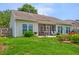 Well-maintained backyard with patio, screened porch, manicured lawn, flower beds, and a grill, ideal for relaxation at 5011 W Liberty Meadows Dr, Summerville, SC 29485