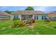 Beautiful backyard with manicured landscaping, a screened porch, and lush greenery creating a serene outdoor oasis at 5011 W Liberty Meadows Dr, Summerville, SC 29485