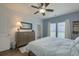Inviting bedroom with neutral tones, a large dresser, ceiling fan, hardwood floors, and a serene atmosphere at 5011 W Liberty Meadows Dr, Summerville, SC 29485