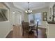 Elegant dining room features a trey ceiling, modern chandelier, and hardwood floors at 5011 W Liberty Meadows Dr, Summerville, SC 29485
