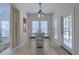 Bright and inviting dining room featuring a stylish table and chairs, bathed in natural light from the windows at 5011 W Liberty Meadows Dr, Summerville, SC 29485