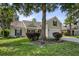 Suburban two-story home with green lawn, flowering bushes, and an attached two car garage at 5011 W Liberty Meadows Dr, Summerville, SC 29485