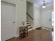 Home foyer with hardwood flooring, staircase, closet and decorative display table at 5011 W Liberty Meadows Dr, Summerville, SC 29485