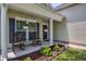 Inviting front porch with rocking chairs, hanging flower baskets and manicured landscaping at 5011 W Liberty Meadows Dr, Summerville, SC 29485
