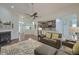 Cozy living room with a fireplace, plush seating, and a seamlessly integrated kitchen at 5011 W Liberty Meadows Dr, Summerville, SC 29485