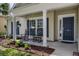Inviting front porch features classic rocking chairs, plants, and a bright front door at 5011 W Liberty Meadows Dr, Summerville, SC 29485