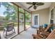 Inviting screened porch with ceiling fan and access to a well-maintained backyard and outdoor seating area at 5011 W Liberty Meadows Dr, Summerville, SC 29485