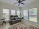 Cozy sun room filled with light is ideal for relaxing and features a large comfortable sofa at 5011 W Liberty Meadows Dr, Summerville, SC 29485