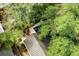 Aerial view of a backyard featuring a pool and fire pit, surrounded by lush trees at 509 Klein St, Mount Pleasant, SC 29464