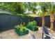 Backyard features a garden, gravel, Adirondack chairs, palm trees, and privacy fence at 509 Klein St, Mount Pleasant, SC 29464