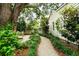 Charming backyard pathway winding through lush landscaping, leading to a cozy seating area at 509 Klein St, Mount Pleasant, SC 29464