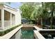 Backyard features a swimming pool with spa, outdoor kitchen, seating and landscaping at 509 Klein St, Mount Pleasant, SC 29464