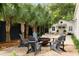 Inviting backyard with comfortable seating, a fire pit, and lush palm trees creating a relaxing outdoor space at 509 Klein St, Mount Pleasant, SC 29464