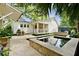 Backyard features a swimming pool with spa, outdoor kitchen, landscaping and covered porch at 509 Klein St, Mount Pleasant, SC 29464