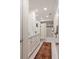 Bright bathroom features a patterned runner rug, white hexagon tile floor and shaker style vanity at 509 Klein St, Mount Pleasant, SC 29464