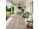 Inviting front porch area, featuring an elegant outdoor rug, neutral seating, and classic white columns at 509 Klein St, Mount Pleasant, SC 29464