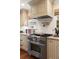 Kitchen featuring a stainless steel range, marble countertops and backsplash, and custom range hood at 509 Klein St, Mount Pleasant, SC 29464