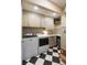 Well-organized laundry room with black and white tile flooring and neutral-toned cabinetry for ample storage space at 509 Klein St, Mount Pleasant, SC 29464