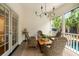 Relaxing covered patio features wicker furniture, chandelier and views of the pool at 509 Klein St, Mount Pleasant, SC 29464