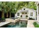 Stylish pool and spa with a classic white cottage backdrop, creating a serene backyard retreat at 509 Klein St, Mount Pleasant, SC 29464