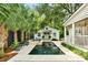 Beautiful pool area with a jacuzzi, surrounded by lush landscaping and a charming cottage-style building at 509 Klein St, Mount Pleasant, SC 29464