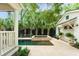 Backyard pool with spa features travertine pavers, seating, privacy fence and landscaping at 509 Klein St, Mount Pleasant, SC 29464