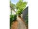 A landscaped walkway provides a charming path alongside the house at 509 Klein St, Mount Pleasant, SC 29464