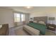 Bright bedroom featuring neutral walls, carpet floors, and a large window for natural light at 5302 Bending Flats Way, Summerville, SC 29485