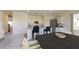 Modern kitchen with white cabinets, granite countertops, stainless steel appliances, and an eat-in island with barstool seating at 5313 Bending Flats Way, Summerville, SC 29485