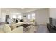 Bright, open-concept living area with modern furnishings and a seamless transition to the adjacent kitchen and dining space at 5313 Bending Flats Way, Summerville, SC 29485