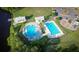 Aerial view of a community pool area with swimming pools, a playground, and parking at 558 Pendleton Dr, Moncks Corner, SC 29461