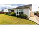 Spacious backyard features lush green grass, tidy landscaping, and a covered patio, with a storage shed at 558 Pendleton Dr, Moncks Corner, SC 29461