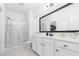 Modern bathroom features white cabinets, a large black framed mirror, and glass shower at 558 Pendleton Dr, Moncks Corner, SC 29461