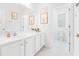 Bright bathroom features a white vanity with sink, a large mirror, and framed animal artwork above the toilet at 558 Pendleton Dr, Moncks Corner, SC 29461
