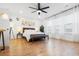 Spacious main bedroom with plenty of natural light, wood floors, a ceiling fan, and a sitting area at 558 Pendleton Dr, Moncks Corner, SC 29461